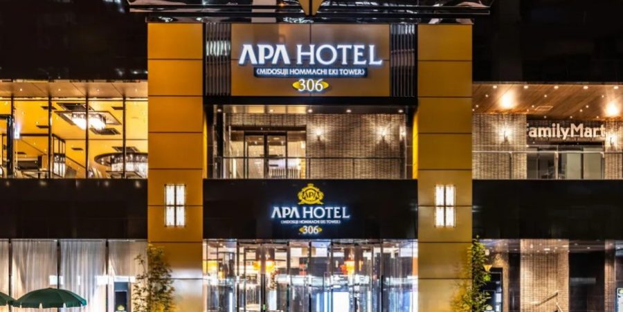 A nighttime view of a hotel exterior, with glowing lights highlighting its architectural features and inviting entrance.